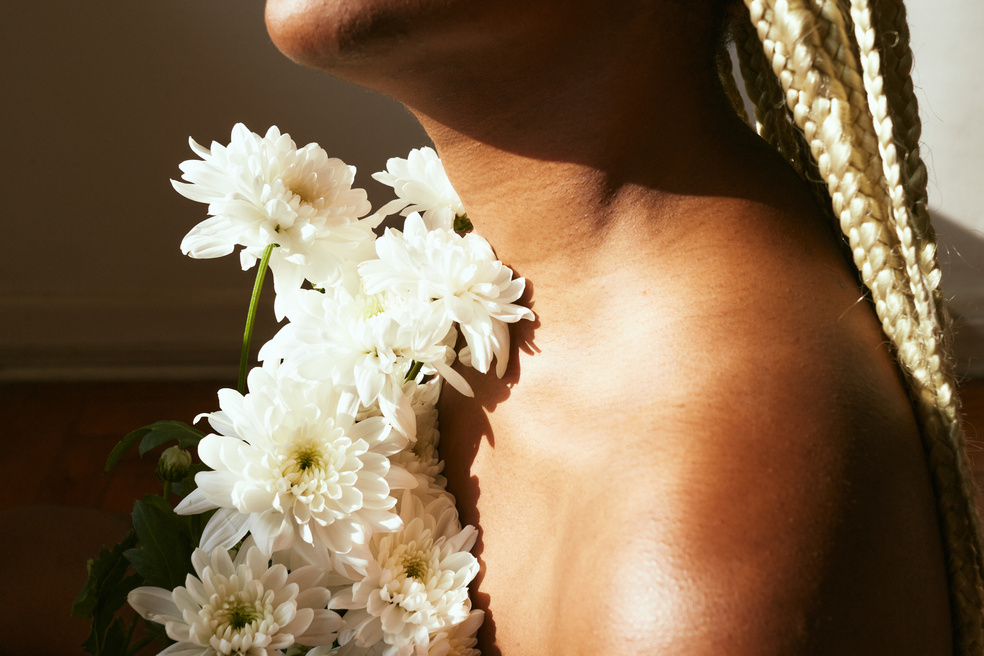 Woman with Flowers and Dramatic Lighting